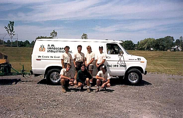 RM Landscape crew posing with a company service truck